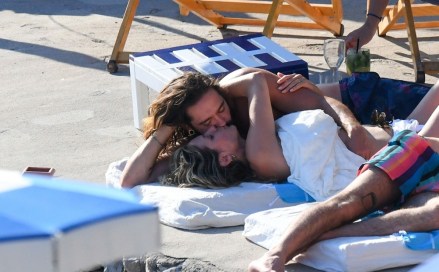 ** RIGHTS: ONLY UNITED STATES, BRAZIL, CANADA ** Capri, ITALY  - *EXCLUSIVE*  - Newly married couple, the German Model Heidi Klum is spotted kissing with her musician husband Tom Kaulitz out in Capri. The couple who married on the idyllic island were spotted on the beach enjoying a passionate little kiss and a cuddle as they sizzled in the Italian sunshine. It all seemed too much for Heidi with the all this heat of affection as the model decided to raise the temperatures of her own even higher by taking off her stunning white swimsuit and went topless with her long haired beau Tom showing off his manly physique. Tom's brother Bill Kaulitz was also spotted enjoying his time in blazing sunshine with the happy couple. *Shot on 08/04/19*Pictured: Heidi Klum - Tom KaulitzBACKGRID USA 5 AUGUST 2019 USA: +1 310 798 9111 / usasales@backgrid.comUK: +44 208 344 2007 / uksales@backgrid.com*UK Clients - Pictures Containing ChildrenPlease Pixelate Face Prior To Publication*