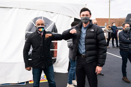IMAGE DISTRIBUTED FOR THE HUMAN RIGHTS CAMPAIGN - Alphonso David, president of the Human Rights Campaign (lefts) poses with Jon Ossoff during a drive-in, get-out-the-vote rally at Santa Fe Mall on Sunday Dec. 20, 2020 in Duluth, Ga. The rally was for democrats Rev. Raphael Warnock and Mr. Ossoff ahead of their Senate runoff in January. (Kevin Liles/AP Images for The Human Rights Campaign)