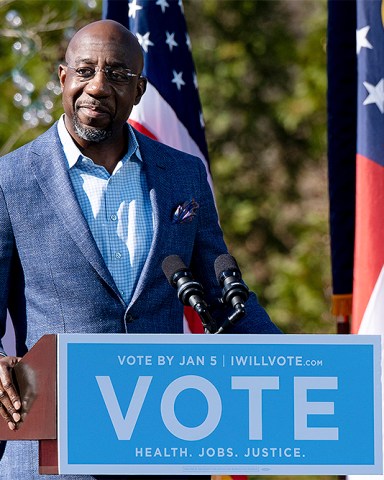 FILE - In this Dec. 21, 2020, file photo Democratic U.S. Senate challenger the Rev. Raphael Warnock speaks during a rally in Columbus, Ga. with Vice President-elect Kamala Harris and fellow Democratic U.S. Senate challenger Jon Ossoff. (AP Photo/Ben Gray, File)
