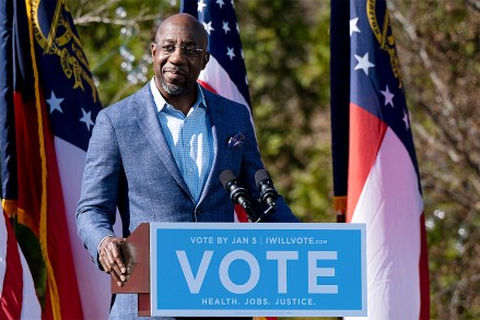 FILE - In this Dec. 21, 2020, file photo Democratic U.S. Senate challenger the Rev. Raphael Warnock speaks during a rally in Columbus, Ga. with Vice President-elect Kamala Harris and fellow Democratic U.S. Senate challenger Jon Ossoff. (AP Photo/Ben Gray, File)