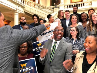 The Rev. Raphael Warnock, a Georgia Democrat, greets supporters at the state Capitol in Atlanta on Friday, March 6, 2020. Warnock filed paperwork to appear on the Nov. 3 ballot for Georgia’s special U.S. Senate election. (AP Photo/Benjamin Nadler)