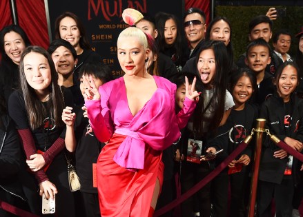 Singer Christina Aguilera poses with fans at the premiere of the film "Mulan" at the El Capitan Theatre, Monday, March 9, 2020, in Los Angeles. (AP Photo/Chris Pizzello)