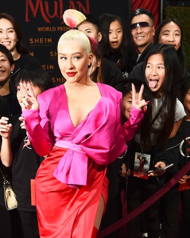 Singer Christina Aguilera poses with fans at the premiere of the film "Mulan" at the El Capitan Theatre, Monday, March 9, 2020, in Los Angeles. (AP Photo/Chris Pizzello)