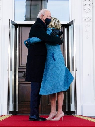President Joe Biden hugs first lady Jill Biden as they arrive at the North Portico of the White House, Wednesday, Jan. 20, 2021, in Washington. (AP Photo/Evan Vucci)