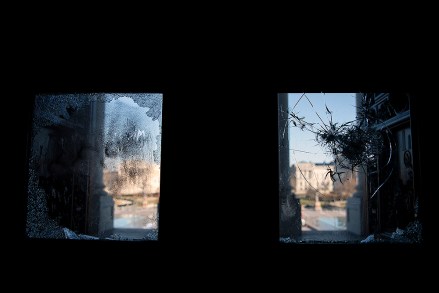 UNITED STATES - January 7: The East Front of the U.S. Capitol is seen through a shattered door leading to the center steps in Washington on Thursday, Jan. 7, 2021, following the riot at the Capitol the day before. (Photo by Caroline Brehman/CQ Roll Call via AP Images)