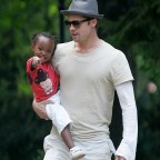 Actor Brad Pitt carries Zahara into a pre-school in Prague