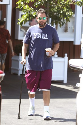 Brentwood, CA - *EXCLUSIVE* - Comedian Adam Sandler was seen stepping out with his wife Jackie this morning to grab some breakfast and coffee.  Adam looked to be in good spirits despite using a walking cane today.  Pictured: Adam Sandler BACKGRID USA 5 SEPTEMBER 2022 USA: +1 310 798 9111 / usasales@backgrid.com UK: +44 208 344 2007 / uksales@backgrid.com *UK Clients - Pictures Containing Children Please Pixelate Face Prior To Publication*