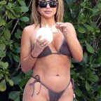 EXCLUSIVE: Larsa Pippen, who was last linked to NBA player Malik Beasley, wears a bikini as she relaxes with a tattoo'd mystery man by the pool in Miami