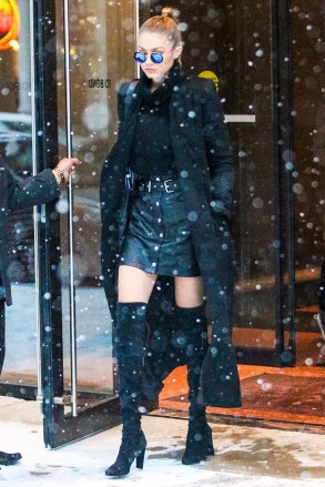 New York, NY - New York, NY - Gigi Hadid is a busy girl! The supermodel has been seen all around the Big Apple for New York Fashion Week. She was spotted leaving in an all black and chic outfit with a pair of iridescent sunglasses. Hadid didn't let the freezing snow prevent her from wearing a pair of thigh high boots and a mini skirt.    AKM-GSI 15 FEBRUARY 2016 To License These Photos, Please Contact : Maria Buda (917) 242-1505 mbuda@akmgsi.comor  Steve Ginsburg (310) 505-8447 (323) 423-9397 steve@akmgsi.com sales@akmgsi.com