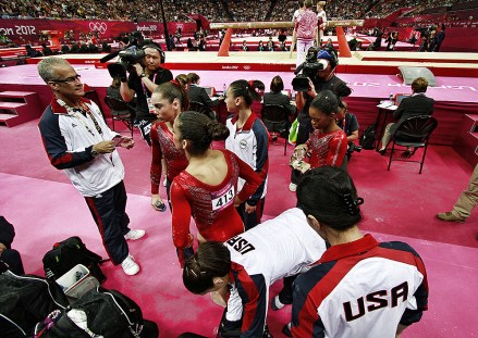 Head Coach  John Geddert Coach of The United States women's Gymnastics team and longtime owner of Twistars Gymnastics Club in Dimondale  prepares with team members Jordyn Wieber, Gabby Douglas, Aly Raisman, McKayla Maroney and Kayla Ross their final turn during the Women's Team Gymnastics competition at North Greenwich Arena, Tuesday, July 31, 2012, in London. the women defeated the Russians to take the gold medal in team competition. (AP Photo/Marc Serota)