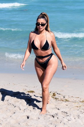 EXCLUSIVE: Larsa Pippen shows off her famous curves in a unique belted bikini that says "salty" as she hits the beach in Miami. 27 Feb 2021 Pictured: Larsa Pippen. Photo credit: MEGA TheMegaAgency.com +1 888 505 6342 (Mega Agency TagID: MEGA736201_001.jpg) [Photo via Mega Agency]