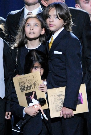 Paris Jackson, left, Prince Michael Jackson I and Prince Michael Jackson II on stage during the memorial service for Michael Jackson at the Staples Center in Los Angeles, Tuesday, July 7, 2009. (AP Photo/Mark J. Terrill, Pool)