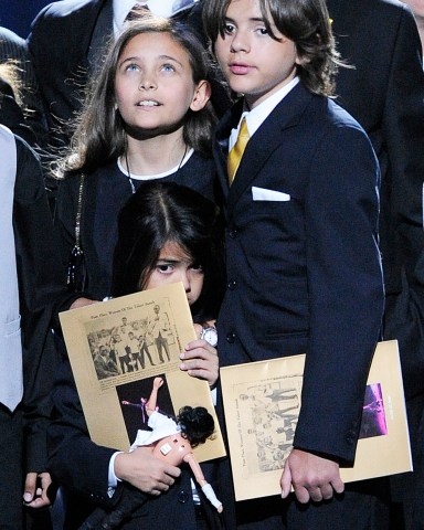 Paris Jackson, left, Prince Michael Jackson I and Prince Michael Jackson II on stage during the memorial service for Michael Jackson at the Staples Center in Los Angeles, Tuesday, July 7, 2009. (AP Photo/Mark J. Terrill, Pool)