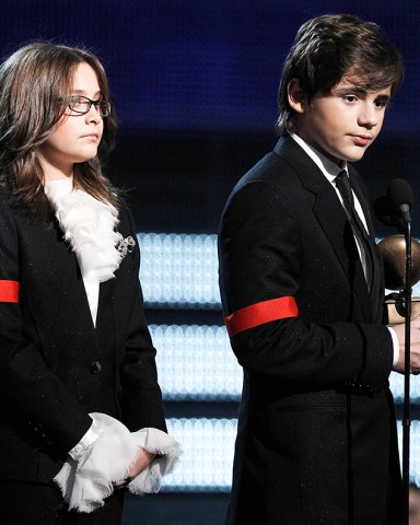 Michael Jackson's children Paris, left, and Prince Michael Jackson II accept the Lifetime Achievement award on behalf of their father at the Grammy Awards on Sunday, Jan. 31, 2010, in Los Angeles.  (AP Photo/Matt Sayles)