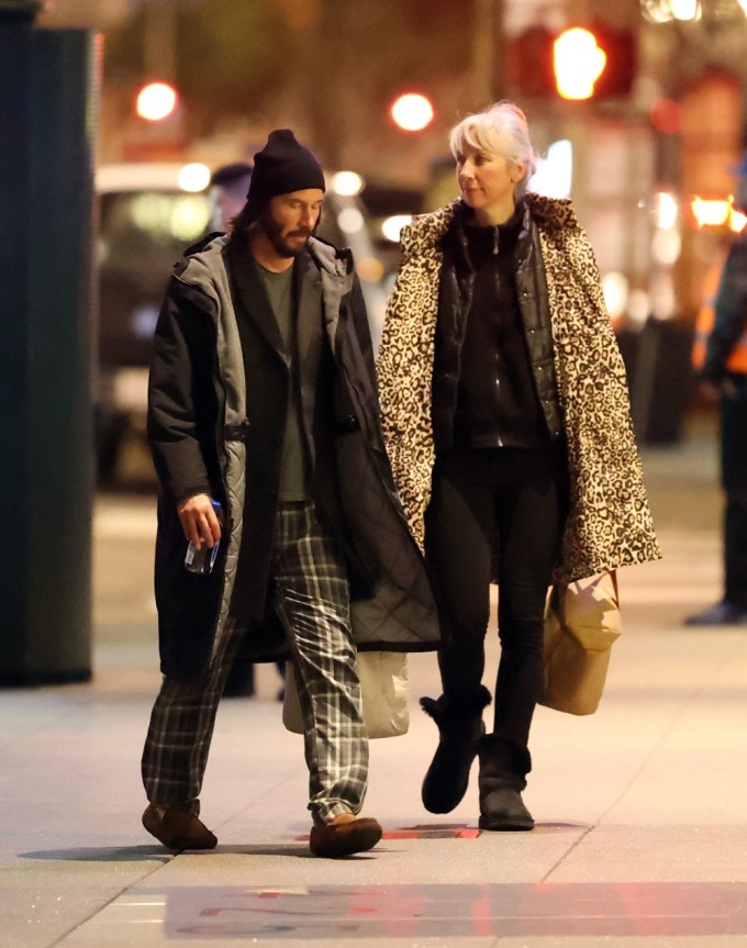 Keanu Reeves and Alexandra Grant walking outside