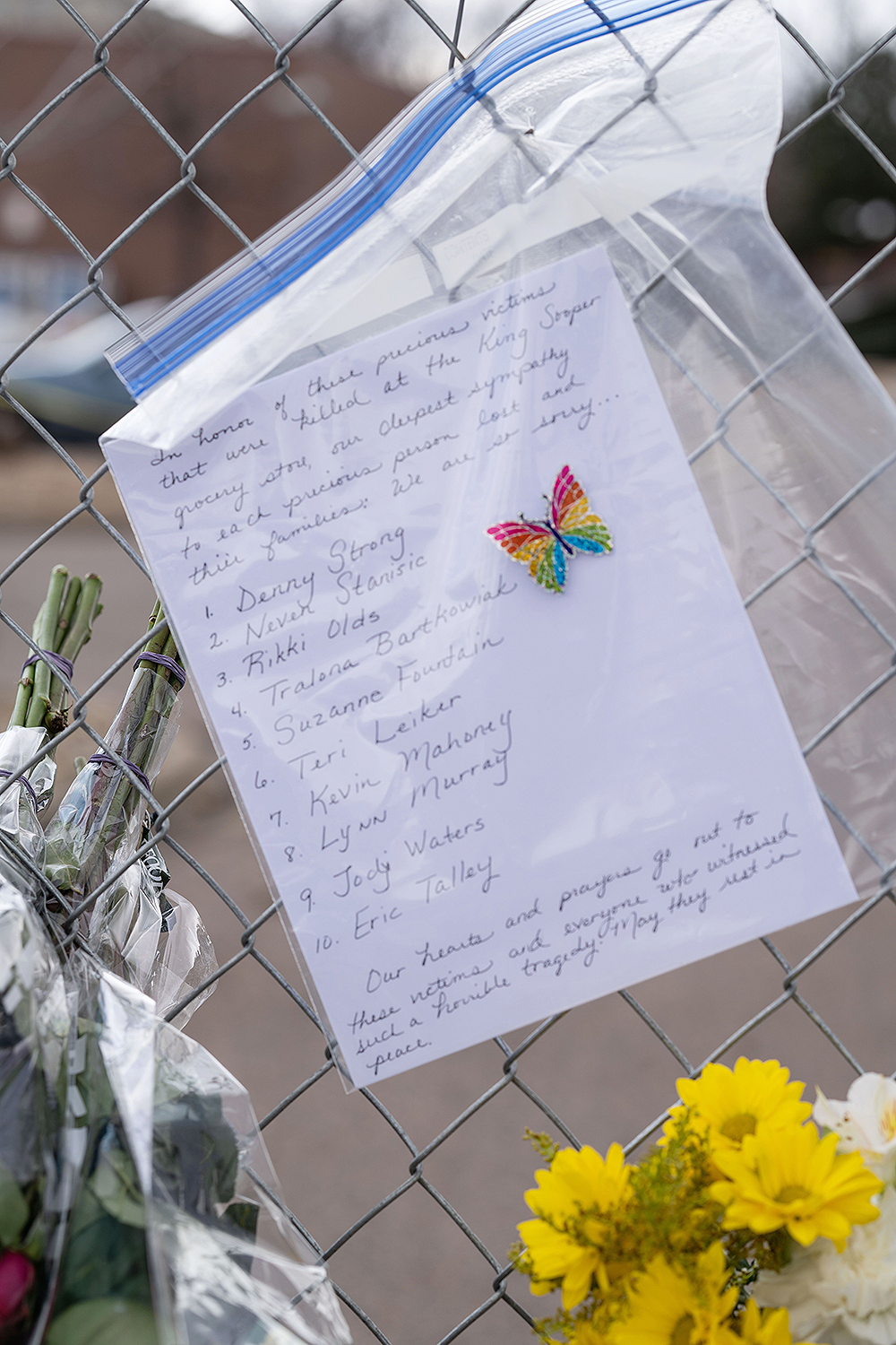 People lay flowers at a growing memorial at the scene a day after Ahmad Al Aliwi Alissa was alleged to have killed ten people including a police officer and is facing ten murder charges at the King Soopers supermarket in Boulder, Colorado, USA, 23 March 2021. Boulder Police released the names of all ten victims as Denny Strong, 20, Neven Stanisic, 23, Rikki Olds, 25, Tralona Bartkowiak, 49, Suzanne Fountain, 59, Teri Leiker, 51, Eric Talley, 51, Kevin Mahoney, 61, Lynn Murray, 62 and Jody Waters, 65.Mass shooting in Colorado, Boulder, USA - 23 Mar 2021