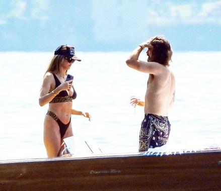 Torno, ITALY - *EXCLUSIVE* - German Model Heidi Klum and her husband, Tokio Hotel's Tom Kaulitz pack on the PDA during their motorboat ride out in Torno, Lake Como.They enjoyed a few drinks on the boat and set the temperatures soaring even further with a loved-up display as they kissed passionately out in the Italian sunshine as Tom when shirtless and took control of the wheel! The former Victoria's Secret Angel Heidi donned her sexy Versace two-piece bikini set.The couple was seen checking out a few properties for sale in the prestigious affluent area where the likes of A-list Hollywood superstars such as George Clooney are residing. Perhaps it's an exciting attractive move for Heidi and Tom as they look to purchase a home in Northern Italy’s Lombardy region known for its stunning dramatic scenery.Pictured: Heidi Klum - Tom KaulitzBACKGRID USA 29 JUNE 2023 BYLINE MUST READ: Cobra Team / BACKGRIDUSA: +1 310 798 9111 / usasales@backgrid.comUK: +44 208 344 2007 / uksales@backgrid.com*UK Clients - Pictures Containing ChildrenPlease Pixelate Face Prior To Publication*