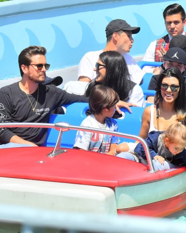 Kourtney Kardashian celebrated her birthday with Scott Disick and her kids at Disneyland. Kourtney also brought her neice North West along, whohad a great time on the carousel. The family were seen enjoying several rides including 'It's A Small World' 'Thunder Mountain' 'Dumbo' and 'Mr Toad's Wild Adventure'. The group brought along a couple of their own bodyguards and were joined by Disneylands head of security. 18 Apr 2017 Pictured: Kourtney Kardashian, Scott Disick, Mason Disick, Penelope Disick, Reign Disick, North West. Photo credit: Snorlax / MEGA TheMegaAgency.com +1 888 505 6342 (Mega Agency TagID: MEGA30260_003.jpg) [Photo via Mega Agency]