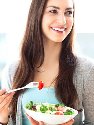 Woman eating salad
