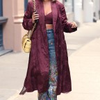 Chrissy Teigen Is Spotted In A Bordeaux Embroidered Coat And Matching Bra At Material Good In New York City