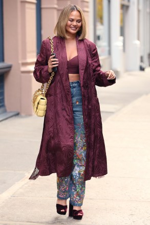 Chrissy Teigen is spotted in a Bordeaux embroidered coat and matching bra, embroidered jeans, crushed velvet platform heels and yellow quilted bag at Material Good in New York City.Pictured: Chrissy TeigenRef: SPL5270646 281021 NON-EXCLUSIVEPicture by: Christopher Peterson / SplashNews.comSplash News and PicturesUSA: +1 310-525-5808London: +44 (0)20 8126 1009Berlin: +49 175 3764 166photodesk@splashnews.comWorld Rights