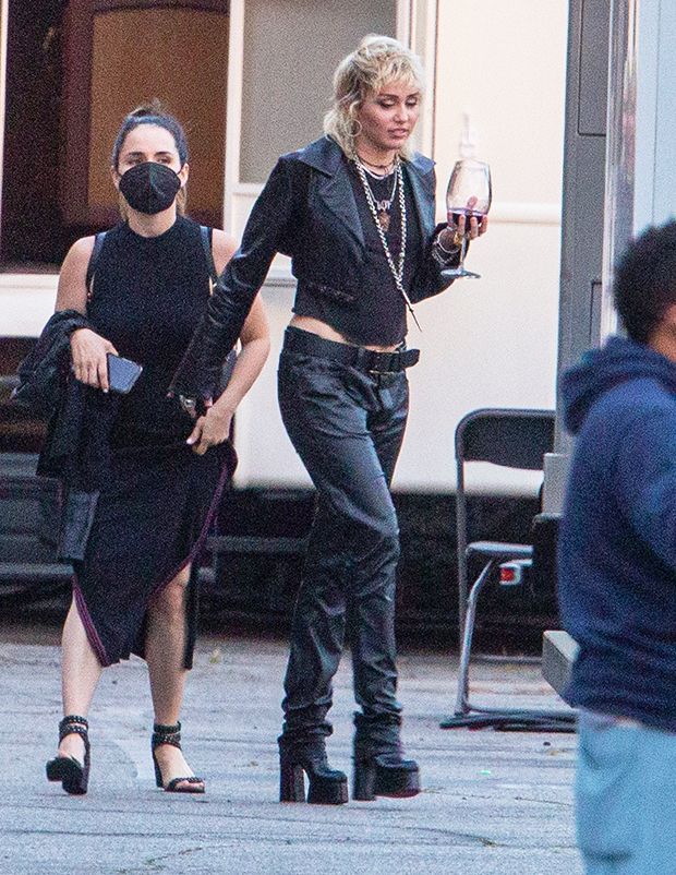Miley Cyrus rocks black leather pants with Louis Vuitton sneakers