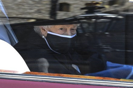 Britain's Queen Elizabeth II follows the coffin in a car as it makes it's way past the Round Tower during the funeral of Britain's Prince Philip inside Windsor Castle in Windsor, England
Prince Philip Funeral, Windsor, United Kingdom - 17 Apr 2021