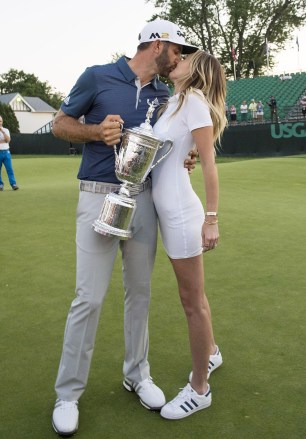 Dustin Johnson hugs Paulina Gretzky as he holds the championship trophy on the 18th green after winning his first major championship in the final round at the U.S. Open at Oakmont Country Club near Pittsburgh, Pennsylvania on June 19, 2016. Johnson has won with a score of 5 under par.  Us Open Golf 2016, Oakmont, PA, USA - June 19, 2016