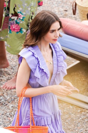 Saint-Jean-Cap-Ferrat, FRANCE  - British-American actress Lily Collins pictured in character while on set filming scenes for season 2 of Netflix series 'Emily In Paris' in Saint-Jean-Cap-Ferrat, France.Pictured: Lily CollinsBACKGRID USA 4 MAY 2021 USA: +1 310 798 9111 / usasales@backgrid.comUK: +44 208 344 2007 / uksales@backgrid.com*UK Clients - Pictures Containing ChildrenPlease Pixelate Face Prior To Publication*