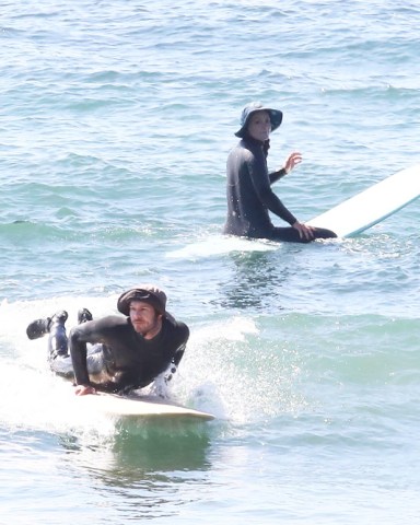 Malibu, CA  - *EXCLUSIVE*  - Actors Adam Brody and Leighton Meester get their surf on in Malibu. The couple suited up in wetsuits and enjoyed their morning riding waves. Leighton carries her surfboard as she walks back to land.  Pictured: Adam Brody and Leighton Meester  BACKGRID USA 17 MARCH 2022   USA: +1 310 798 9111 / usasales@backgrid.com  UK: +44 208 344 2007 / uksales@backgrid.com  *UK Clients - Pictures Containing Children Please Pixelate Face Prior To Publication*