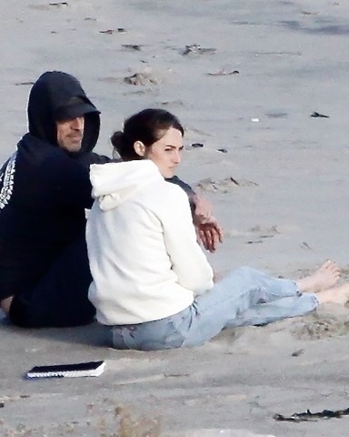 *EXCLUSIVE* Malibu, CA  - Actress Shailene Woodley and her football star fiancee Aaron Rodgers cuddle together with their dog as they take in the lovely Malibu sunset.  The couple recently announced they are engaged and Shailene was spotted wearing the sparkler.  Shailene had a notebook that she read from and they both took turns tossing the German Shepherd a tennis ball to fetch.  Pictured: Shailnee Woodley, Aaron Rodgers  BACKGRID USA 8 APRIL 2021   BYLINE MUST READ: BACKGRID  USA: +1 310 798 9111 / usasales@backgrid.com  UK: +44 208 344 2007 / uksales@backgrid.com  *UK Clients - Pictures Containing Children Please Pixelate Face Prior To Publication*