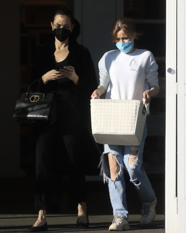 West Hollywood, CA  - *EXCLUSIVE*  - Actress Angelina Jolie was spotted busy on the phone while leaving the container store at The Grove with her daughter, Shiloh Jolie-Pitt, who did most of the lifting.  Pictured: Angelina Jolie, Shiloh Jolie-Pitt   BACKGRID USA 11 MARCH 2022   BYLINE MUST READ: BACKGRID  USA: +1 310 798 9111 / usasales@backgrid.com  UK: +44 208 344 2007 / uksales@backgrid.com  *UK Clients - Pictures Containing Children Please Pixelate Face Prior To Publication*
