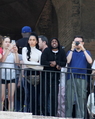 EXCLUSIVE: Kendrick Lamar and girlfriend Whitney Alford on vacation visit the Colosseum in Rome. The famous rapper arrived with his girlfriend and family friends early in the morning but the Colosseum was already packed with tourists. Lamar turned with the hood of the sweatshirt over his head, so as not to be recognized, but with such a huge bodyguard it did not go unnoticed. After they visited the Roman Forums. Then they had lunch in a restaurant in Trastevere. After lunch they went to admire the view of Rome from the Gianicolo hill. 22 Apr 2018 Pictured: kendrick lamar. Photo credit: MEGA TheMegaAgency.com +1 888 505 6342 (Mega Agency TagID: MEGA206743_001.jpg) [Photo via Mega Agency]