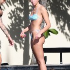 Singer Dua Lipa wears a tiny blue bikini as she shows plenty of PDA with boyfriend Anwar Hadid in Miami