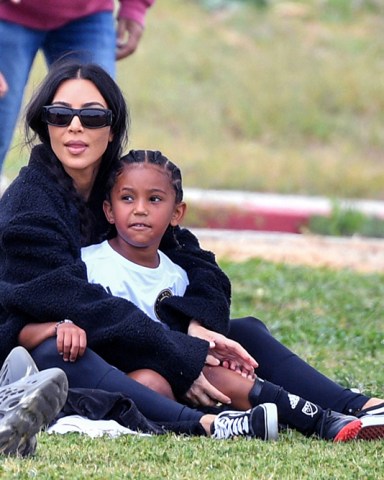 **USE CHILD PIXELATED IMAGES IF YOUR TERRITORY REQUIRES IT**  Kim Kardashian proves she's a total soccer mom as she attends her son Saint's soccer game in Los Angeles Ca. The beauty mogul went low key casual as she hung out with a pal and her eldest daughter North at the local park.  Pictured: Kim Kardashian,Saint West Ref: SPL5301060 030422 NON-EXCLUSIVE Picture by: SplashNews.com  Splash News and Pictures USA: +1 310-525-5808 London: +44 (0)20 8126 1009 Berlin: +49 175 3764 166 photodesk@splashnews.com  World Rights