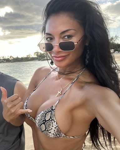 Hawaii, HI  - *EXCLUSIVE*  - Singer Nicole Scherzinger is seen having a little fun in the sun on the beach with her cousins during her sun-soaked holiday in Hawaii.The 44-year-old Pussycat Doll showed off her sultry physique wearing her sexy animal-printed bikini out on Makaha Beach with the family.The sexy star recently revealed some happy news on social media as she announced that she is engaged to her beau Thom Evans after three years of dating.  **SHOT ON 06/26/2023**Pictured: Nicole ScherzingerBACKGRID USA 28 JUNE 2023 USA: +1 310 798 9111 / usasales@backgrid.comUK: +44 208 344 2007 / uksales@backgrid.com*UK Clients - Pictures Containing ChildrenPlease Pixelate Face Prior To Publication*