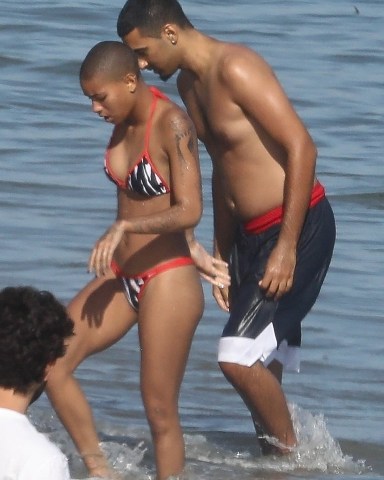 *EXCLUSIVE* Malibu, CA  - Actress and singer Willow Smith and her new male companion share a funny cigarette before cooling off in the ocean together and exchanging phone numbers before going their separate ways.  Pictured: Willow Smith  BACKGRID USA 24 JUNE 2022   BYLINE MUST READ: RMBI / BACKGRID  USA: +1 310 798 9111 / usasales@backgrid.com  UK: +44 208 344 2007 / uksales@backgrid.com  *UK Clients - Pictures Containing Children Please Pixelate Face Prior To Publication*