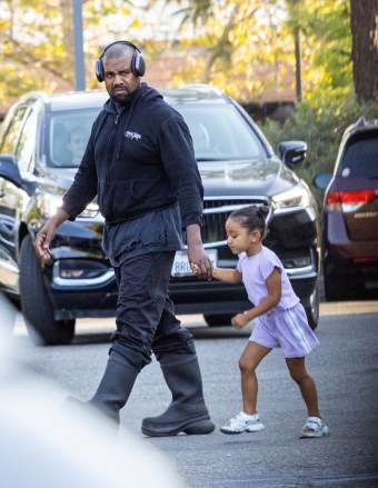 Los Angeles, CA - *EXCLUSIVE* - Kanye West is in dad mode as we spot the rapper/designer at his daughter North's basketball game in Los Angeles.  Kanye holds Chicago's hand as he walks alongside a nanny during North's game.  Pictured: Kanye West BACKGRID USA 29 JULY 2022 USA: +1 310 798 9111 / usasales@backgrid.com UK: +44 208 344 2007 / uksales@backgrid.com