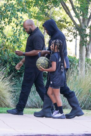 LOS ANGELES, CALIFORNIA - *EXCLUSIVE* - Kanye West meets with daughter North before a basketball game in Los Angeles. North walks next to her father while dribbling a basketball. Her father wears all-black clothes with his trademark rubber boots. PHOTOS: Kanye West, North West BACKGRID USA 29th July 2022 USA: +1 310 798 9111 / usasales@backgrid.com UK: +44 208 344 2007 / uksales@backgrid.com Publications*