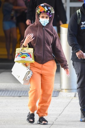 New York, NY  - *EXCLUSIVE*  - A pregnant Cardi B wearing a floral headband and a brown hoodie and orange sweat pants carries two designer handbags as she arrives at JFK Airport in NYC.Pictured: Cardi BBACKGRID USA 9 JULY 2021 USA: +1 310 798 9111 / usasales@backgrid.comUK: +44 208 344 2007 / uksales@backgrid.com*UK Clients - Pictures Containing ChildrenPlease Pixelate Face Prior To Publication*