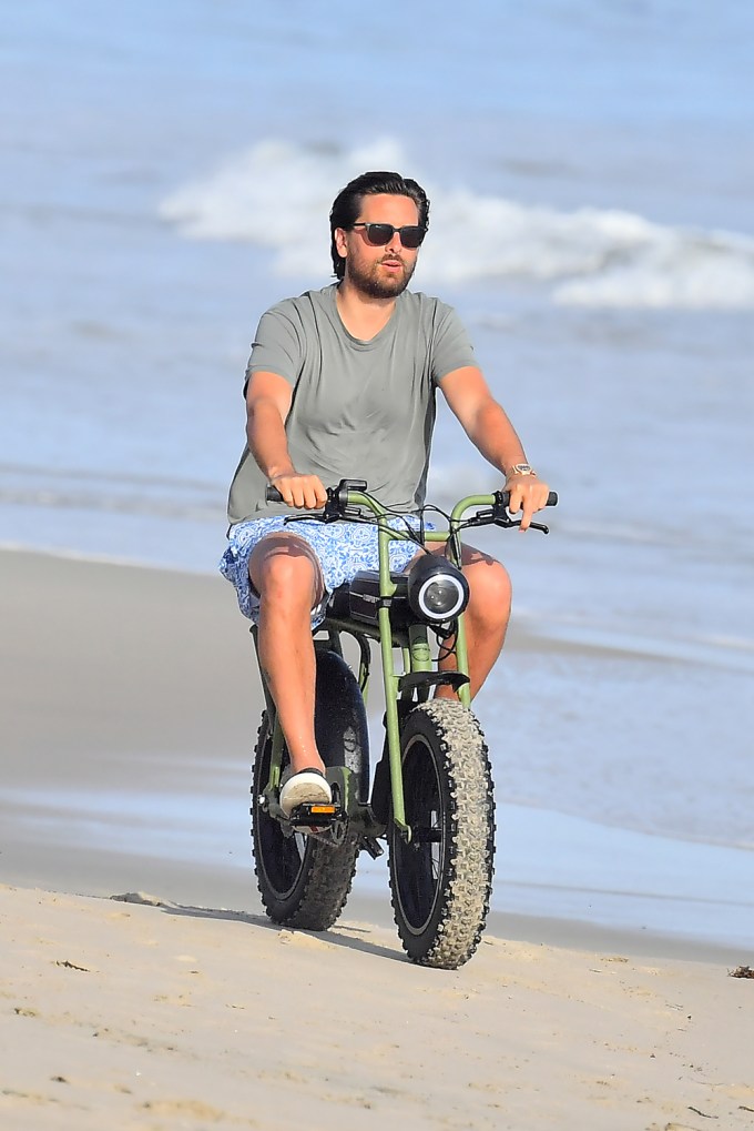 Scott Disick rides his electric dirt bike on the beach in Malibu