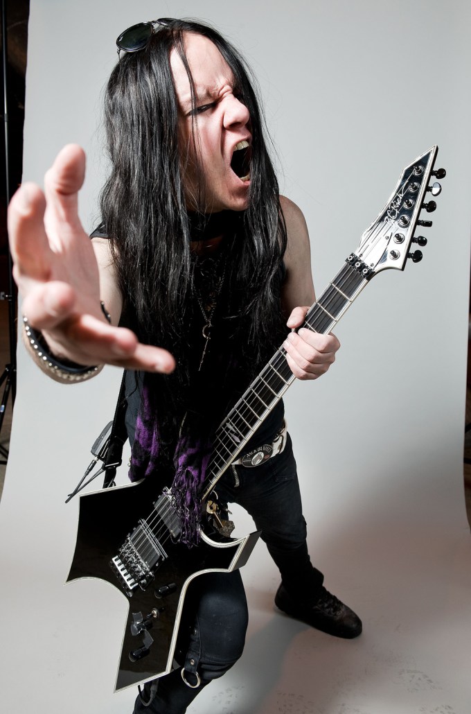 Joey Jordison holds a guitar
