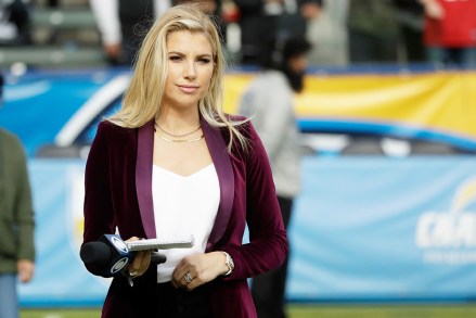 Melanie Collins CBS sideline reporter watches during warm ups before an NFL football game between the Los Angeles Chargers and the Oakland Raiders, in Carson, CalifRaiders Chargers Football, Carson, USA - 22 Dec 2019