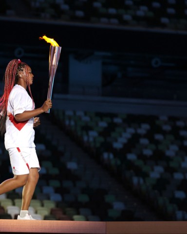 Naomi Osaka carries the Olympic Torch during the opening ceremony in the Olympic Stadium at the 2020 Summer Olympics, in Tokyo, Japan Olympics Opening Ceremony, Tokyo, Japan - 23 Jul 2021