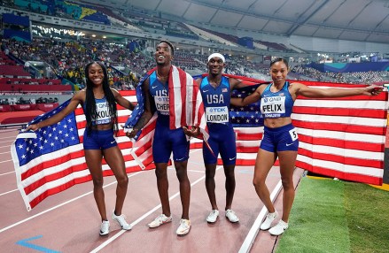 Team USA of Allyson Felix, Wilbert London, Michael Cherry and Courtney Okolo pose after winning the gold medal in the medley 4x400 meter relay at the World Athletics Championships in Doha, Qatar