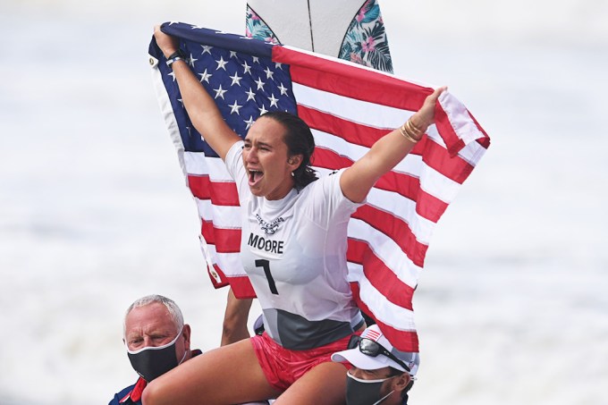 Carissa Moore holds up a flag