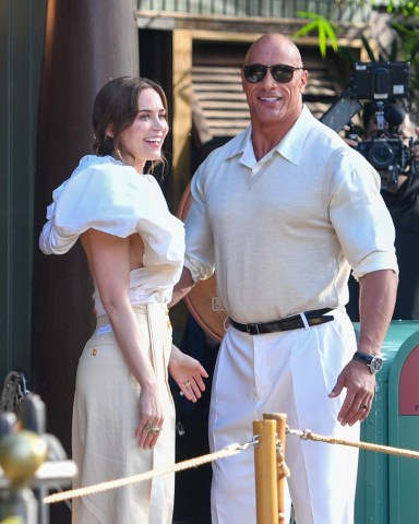 Dwayne 'The Rock' Johnson and his Co-star Emily Blunt promote their new movie Jungle Cruise at Disneyland. Both Co-stars wore all white as they checked out the Jungle Cruise ride at the park. 24 Jul 2021 Pictured: Dwayne 'The Rock' Johnson and Emily Blunt. Photo credit: MEGA TheMegaAgency.com +1 888 505 6342 (Mega Agency TagID: MEGA773876_005.jpg) [Photo via Mega Agency]