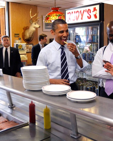 Barack Obama, Michael Bell, Harry Dionyssiou President Barack Obama eats a french fry as he makes an unannounced visit to Rudy's Hot Dog with Toledo Mayor Michael Bell, center, in Toledo, Ohio. Owner Harry Dionyssiou is at right
Obama, Toledo, USA