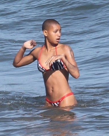 *EXCLUSIVE* Malibu, CA  - Actress and singer Willow Smith and her new male companion share a funny cigarette before cooling off in the ocean together and exchanging phone numbers before going their separate ways.  Pictured: Willow Smith  BACKGRID USA 24 JUNE 2022   BYLINE MUST READ: RMBI / BACKGRID  USA: +1 310 798 9111 / usasales@backgrid.com  UK: +44 208 344 2007 / uksales@backgrid.com  *UK Clients - Pictures Containing Children Please Pixelate Face Prior To Publication*