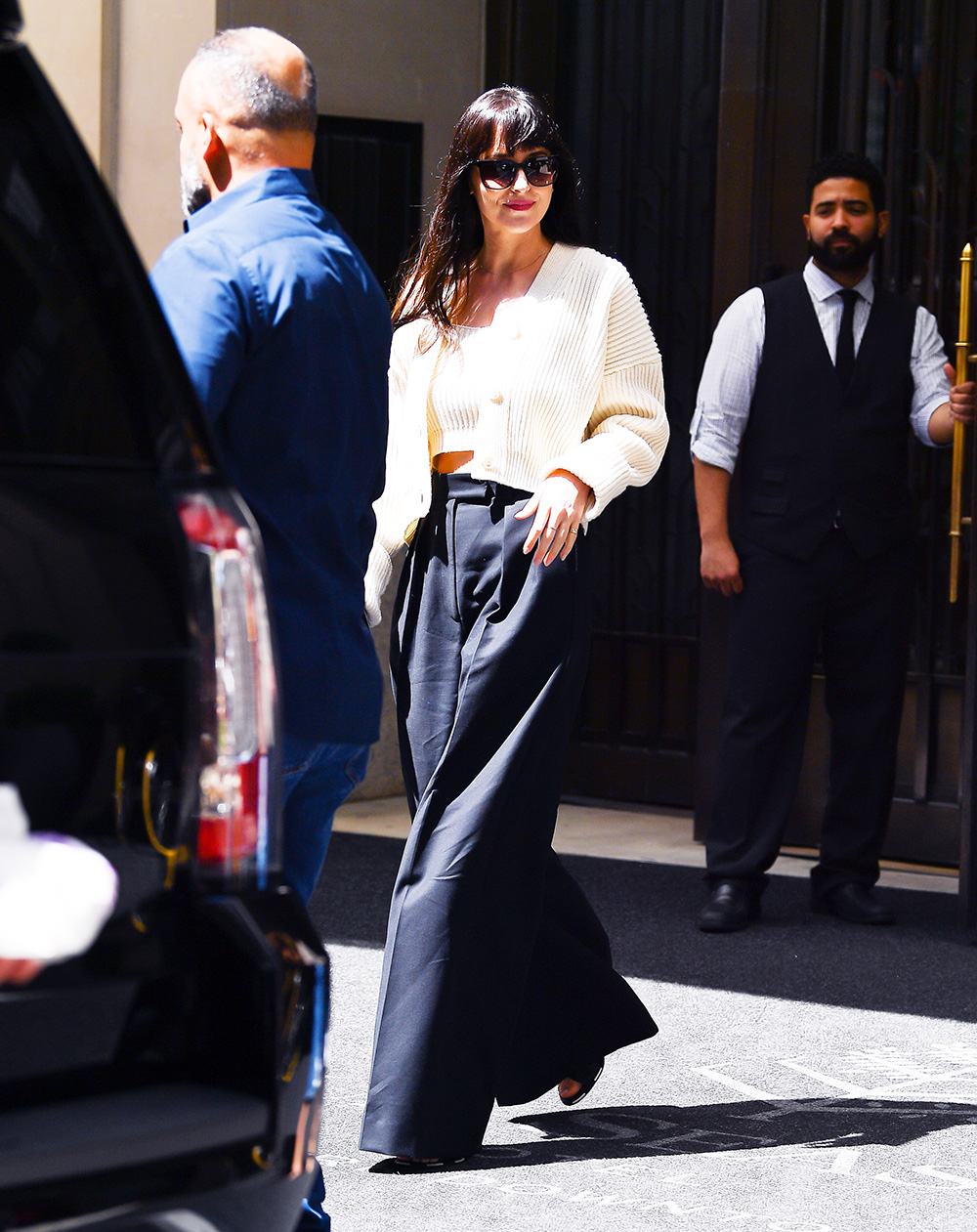 Dakota Johnson Leaves Her Hotel Wearing Bell Bottom Slacks In New York City